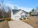 Well-maintained home with a garage, a concrete driveway, and manicured shrubs in a quiet neighborhood at 3517 Glade Run Dr, Sanford, NC 27330