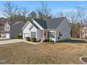 Inviting single-story home featuring a front lawn, a garage, and a welcoming front porch at 3517 Glade Run Dr, Sanford, NC 27330