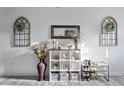Neutral-toned entryway features decorative vases, mirror and shelving at 358 E Painted Way Way, Clayton, NC 27527