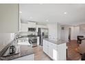 Stylish kitchen featuring white cabinets, granite countertops, stainless appliances, and a kitchen island at 37 Artesa Ct, Fuquay Varina, NC 27526