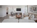 Cozy living room featuring neutral furniture, area rug, and mounted television at 37 Artesa Ct, Fuquay Varina, NC 27526