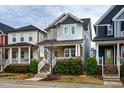 Inviting two-story home with a cozy front porch, complemented by lush green bushes and trees at 376 Granite Mill Blvd, Chapel Hill, NC 27516
