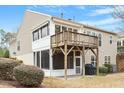 Home's exterior features a deck with stairs leading down to a screened porch and patio at 431 Heralds Way, Cary, NC 27519
