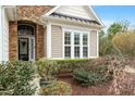 Inviting home entrance with a brick archway, decorative glass door, and manicured landscaping at 431 Heralds Way, Cary, NC 27519