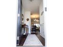 Inviting foyer featuring dark wood floors, a decorative table, and a view into the dining area at 4355 Pond Pine Trl, Morrisville, NC 27560