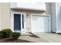Well-maintained townhome with a clean garage, tidy landscaping, and a welcoming blue front door at 4905 Briarstone Ct, Raleigh, NC 27610