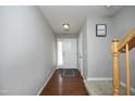 Bright foyer with hardwood floors, neutral walls, and staircase access to the upper level at 4905 Briarstone Ct, Raleigh, NC 27610