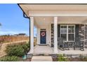 Inviting front porch with rocking chairs and a wreath on the front door offering curb appeal at 59 N Clearbrook Ct, Angier, NC 27501