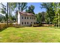 Spacious backyard featuring a well-maintained lawn, wooden fence, and a small deck, perfect for outdoor enjoyment at 612 Lakeview Dr, Raleigh, NC 27603