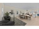 Bright dining area with hardwood floors, modern furnishings, and large windows providing ample natural light at 612 Lakeview Dr, Raleigh, NC 27603