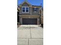 Two-story home with gray siding, brick facade, two-car garage, and concrete driveway at 621 Rockcastle Dr, Cary, NC 27519