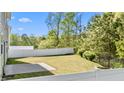 Spacious, green backyard enclosed by a white fence, perfect for outdoor activities and relaxation at 69 Florence Dr, Clayton, NC 27527
