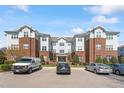 A multi-story building with red brick and gray siding surrounded by a well maintained landscaped parking area at 714 Waterford Lake Dr, Cary, NC 27519