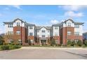 Beautiful condo building featuring brick and siding exterior with a well maintained landscaped entrance at 714 Waterford Lake Dr, Cary, NC 27519