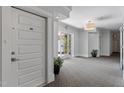 Bright hallway featuring an apartment door, an exit to the exterior, and neutral toned carpet at 714 Waterford Lake Dr, Cary, NC 27519