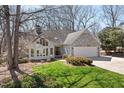 Charming home with stone accents, bright lawn, and an attached two car garage at 8116 Windsor Ridge Dr, Raleigh, NC 27615
