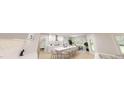 Modern kitchen features sleek white cabinetry, an island with seating, stainless steel appliances, and an adjacent dining area at 8733 Maxine St # 37, Willow Springs, NC 27592