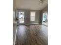 Bright living room with hardwood floors, a fan, and a glass patio door at 912 Pamela Ln, Rocky Mount, NC 27803