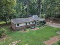 Aerial view of a quaint home with lush greenery, a shed, and a serene, private setting at 913 Ranch Farm Rd, Raleigh, NC 27603