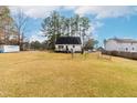 Expansive backyard featuring a large grassy area, perfect for outdoor activities and relaxation at 918 Circle Dr, Angier, NC 27501