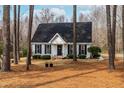 Charming single Gathering home with a well-manicured lawn, black shutters, and a cozy front porch at 918 Circle Dr, Angier, NC 27501