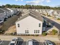 Birds-eye view of townhomes showcasing rear exteriors, parking, and tidy landscaping at 1003 Mirbeck Ln, Durham, NC 27713