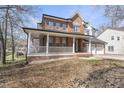 Attractive two-story brick home featuring a welcoming front porch with white columns and a convenient three-car garage at 101 Palmwood Ct, Cary, NC 27519