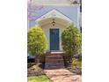 Inviting front entryway with brick steps, mature landscaping, and classic architectural details at 1010 Rosehill Ave, Durham, NC 27705