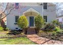 Charming home featuring a brick pathway leading to a covered front porch with manicured landscaping at 1010 Rosehill Ave, Durham, NC 27705