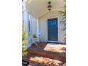 Cozy front porch with brick flooring, a dark teal front door, and seating area at 1010 Rosehill Ave, Durham, NC 27705