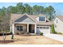 Attractive home with stone accents, shingle siding, a well-manicured lawn, and an attached garage at 1013 Restoration Dr, Durham, NC 27703