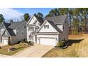Lovely view of home with gray siding, well maintained lawn and landscaping at 104 Vinewood Pl, Holly Springs, NC 27540