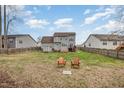 Large backyard featuring mature trees, shed for storage, and a private fence with wooden deck at 1044 S Philwood Ct, Fuquay Varina, NC 27526