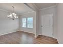 Open dining area with a chandelier and large windows for natural light at 106 Florence Pl, Morrisville, NC 27560
