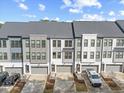View of townhomes featuring a modern design with two car garages and neat landscaping, perfect for convenient living at 1207 Corkery Ridge Ct, Cary, NC 27519