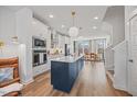 Bright kitchen features modern appliances, a large center island with bar seating, and stylish pendant lighting at 1207 Corkery Ridge Ct, Cary, NC 27519