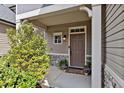 Inviting front porch with a stylish door, lush greenery, and decorative plants adding charm to the entrance at 127 Station Dr, Morrisville, NC 27560