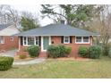 Charming one-story red brick home with a well-manicured lawn and a welcoming front entrance at 1406 Watts St, Durham, NC 27701