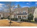 Beautiful two-story home showcasing a blend of stone and siding, complemented by a well-manicured lawn at 1416 Endgame Ct, Wake Forest, NC 27587