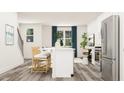 Open floor plan showcasing the kitchen with bar seating and living area with large windows and stylish decor at 1755 Barrett Run Trl # 213, Apex, NC 27502