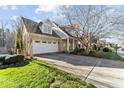 Well maintained home with a spacious driveway and a manicured lawn at 1818 Buxton Way, Burlington, NC 27215