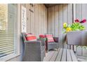 Cozy porch features wicker chairs, bright cushions, and vibrant flower box at 198 Ridge Trl, Chapel Hill, NC 27516