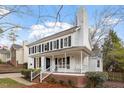 Classic two-story home featuring a welcoming front porch, brick foundation, and tidy landscaping at 2010 Blanchard St, Apex, NC 27502