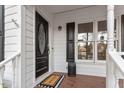 Covered front porch featuring a welcome mat and glass windowed front door at 2010 Blanchard St, Apex, NC 27502