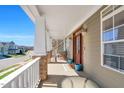Inviting front porch features a seating area, stylish decor, and a beautiful entrance door at 2015 Stanchion St, Haw River, NC 27258