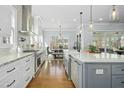 Bright, modern kitchen with white cabinets, stainless steel appliances, and a large center island at 2046 Fellini Dr, Apex, NC 27502