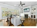 Cozy living room featuring a fireplace, hardwood floors, built-in shelving, and ample natural light at 2046 Fellini Dr, Apex, NC 27502