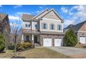 Charming two-story home featuring a two-car garage and landscaped front yard at 205 Virginia Water Dr, Rolesville, NC 27571