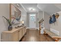 Inviting foyer with hardwood floors, stylish decor, and a staircase leading to the upper level at 205 Virginia Water Dr, Rolesville, NC 27571
