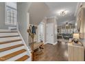 Entryway features hardwood floors, a staircase, and a glimpse into the inviting living spaces at 205 Virginia Water Dr, Rolesville, NC 27571
